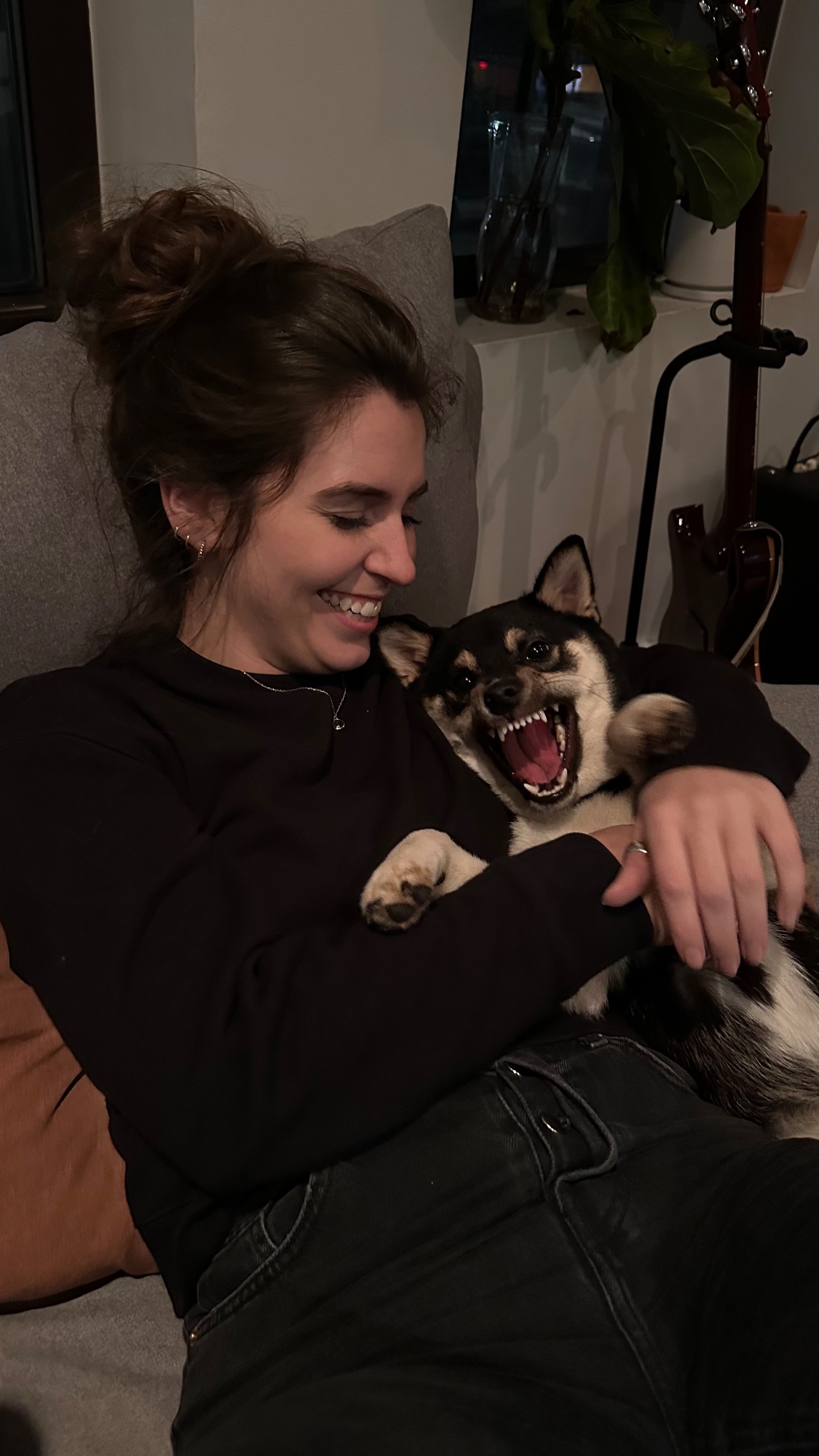 Elise laughing while holding Sierra, who is yelling