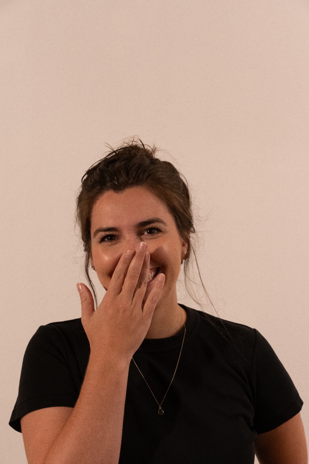 Elise laughing with her hand over her mouth
